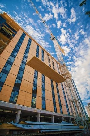 Bottom view of 18-storey Brock Commons construction. Blue sky up ahead.